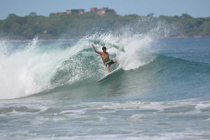 Frontside hack surfing at Playa Grande, Costa Rica