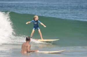 Young kid surfing nice lefts in Playa Tamarindo, Costa Rica