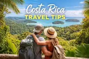 Couple overlooking tropical coastline in Costa Rica with lush jungle and ocean views, representing travel tips for first-time visitors