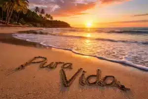 Pura Vida written in the sand on a Costa Rica beach at sunset, representing the country’s lifestyle and culture